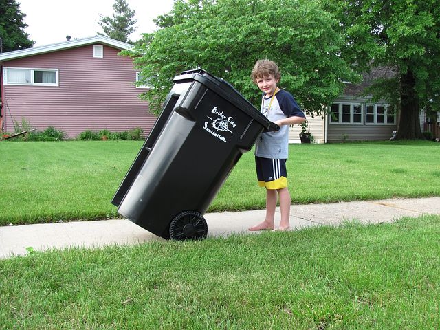 garbage bin and a boy